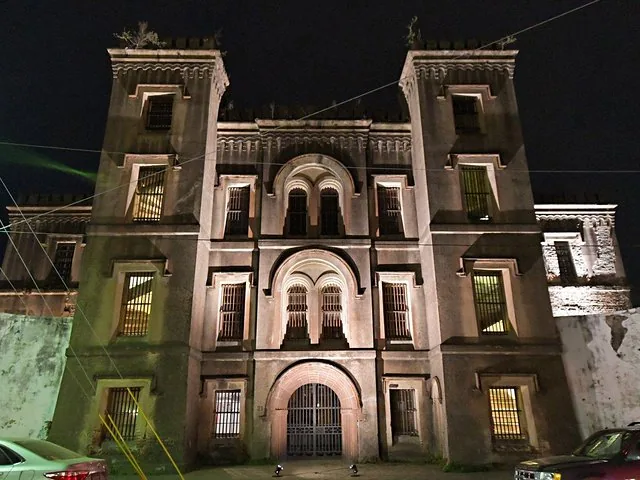 Night view of the imposing exterior of the Old Charleston Jail building.